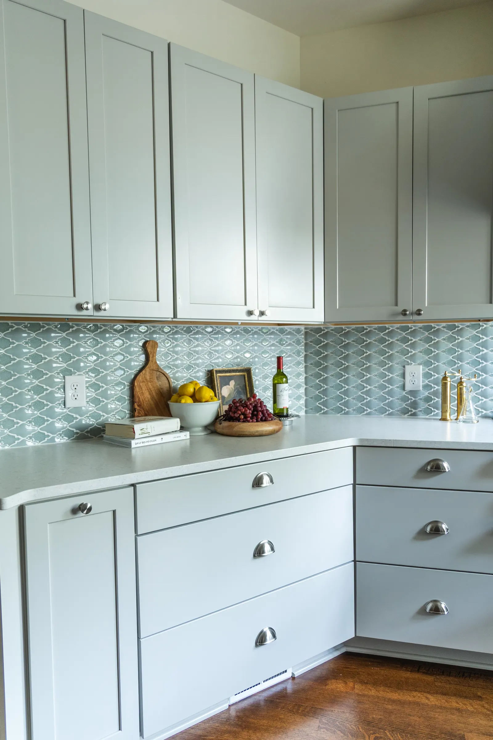 1900 Kitchen Remodel, wood floors, light blue tile backsplash, hardwood floors, open shelving, brushed nickel hardware, wolf oven, stainless steel appliances, custom hood, custom cabinetry, Omaha Nebraska, remodeling and renovations.