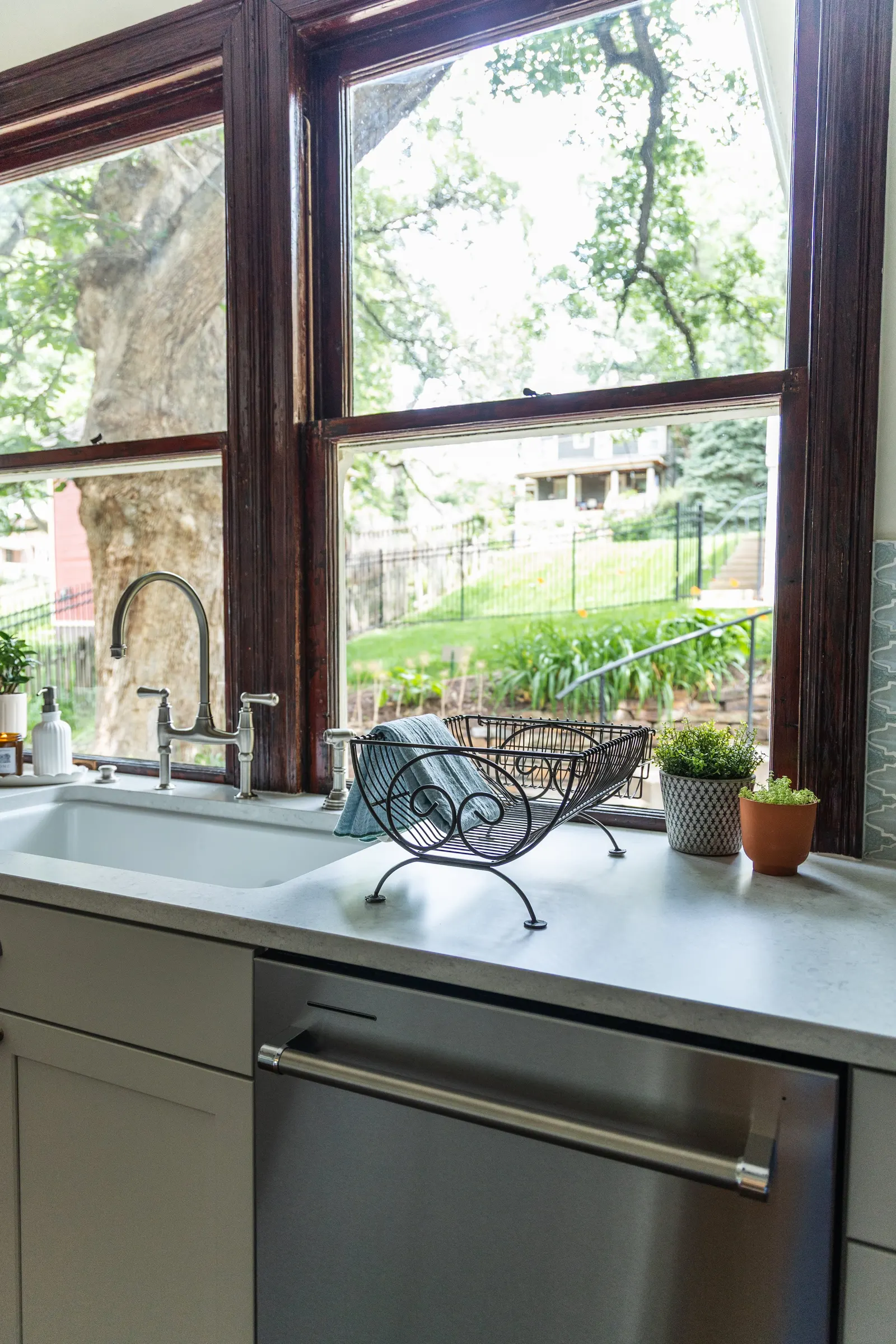 1900 Kitchen Remodel, wood floors, light blue tile backsplash, hardwood floors, open shelving, brushed nickel hardware, wolf oven, stainless steel appliances, custom hood, custom cabinetry, Omaha Nebraska, remodeling and renovations.