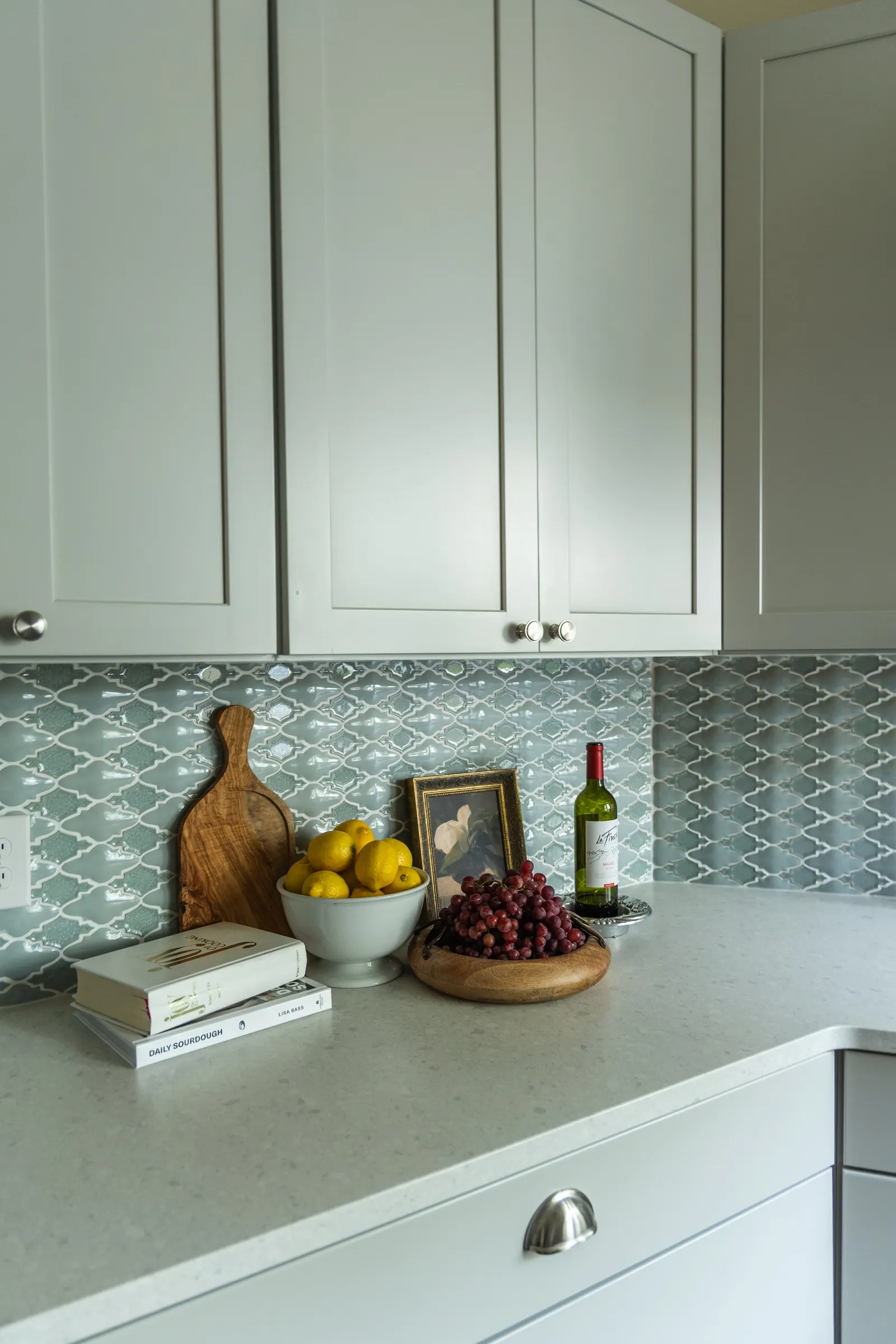 1900 Kitchen Remodel, wood floors, light blue tile backsplash, hardwood floors, open shelving, brushed nickel hardware, wolf oven, stainless steel appliances, custom hood, custom cabinetry, Omaha Nebraska, remodeling and renovations.