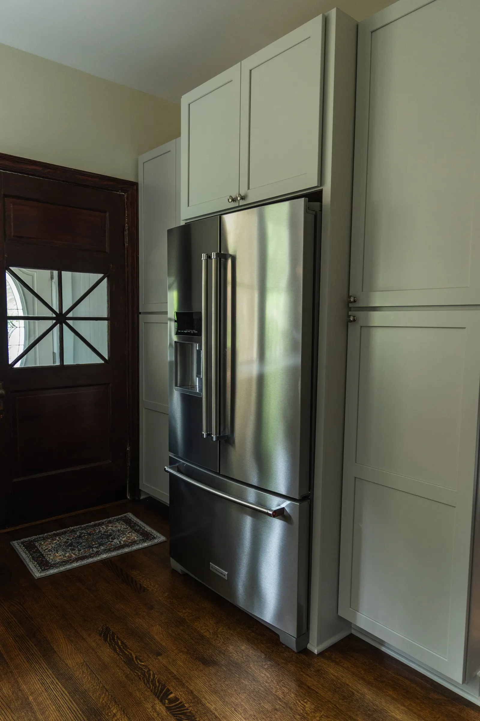 1900 Kitchen Remodel, wood floors, light blue tile backsplash, hardwood floors, open shelving, brushed nickel hardware, wolf oven, stainless steel appliances, custom hood, custom cabinetry, Omaha Nebraska, remodeling and renovations.