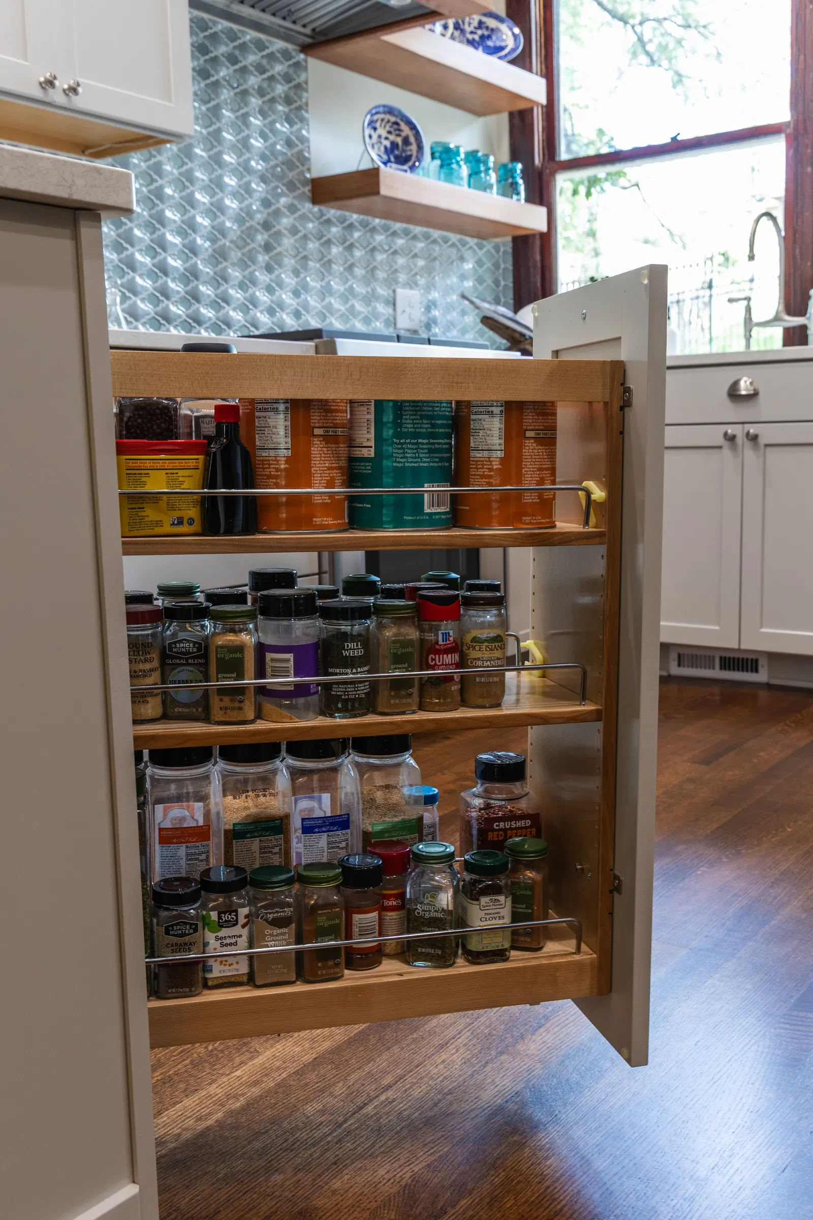 1900 Kitchen Remodel, wood floors, light blue tile backsplash, hardwood floors, open shelving, brushed nickel hardware, wolf oven, stainless steel appliances, custom hood, custom cabinetry, Omaha Nebraska, remodeling and renovations.