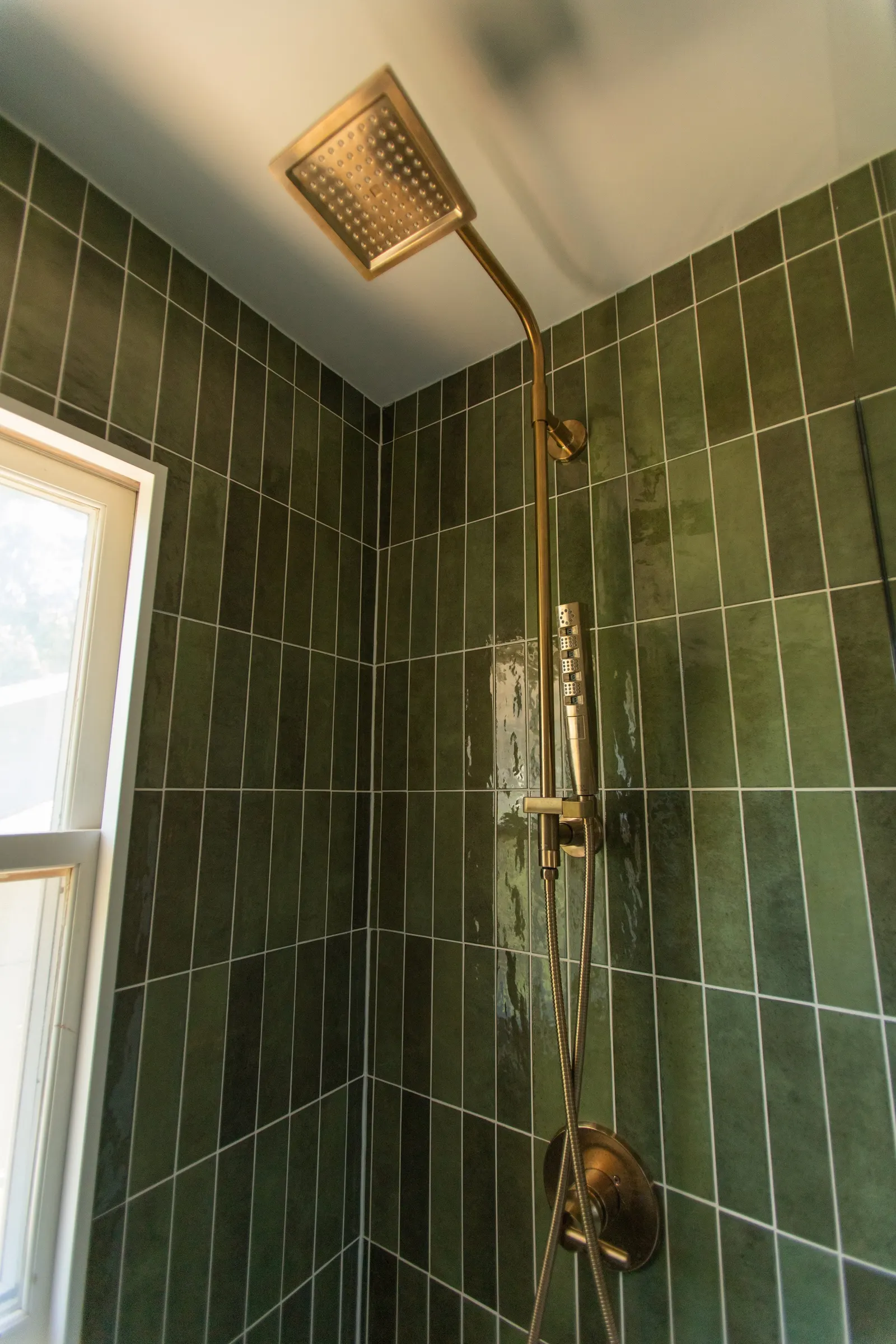 1920 Bathroom Remodel, custom wood vanity, brushed gold hardware, brushed gold sconces, modern design, mixed metal finishes, green subway tile, white hexagon floor tile, Lincoln Nebraska, professional contractors, remodeling and renovations.