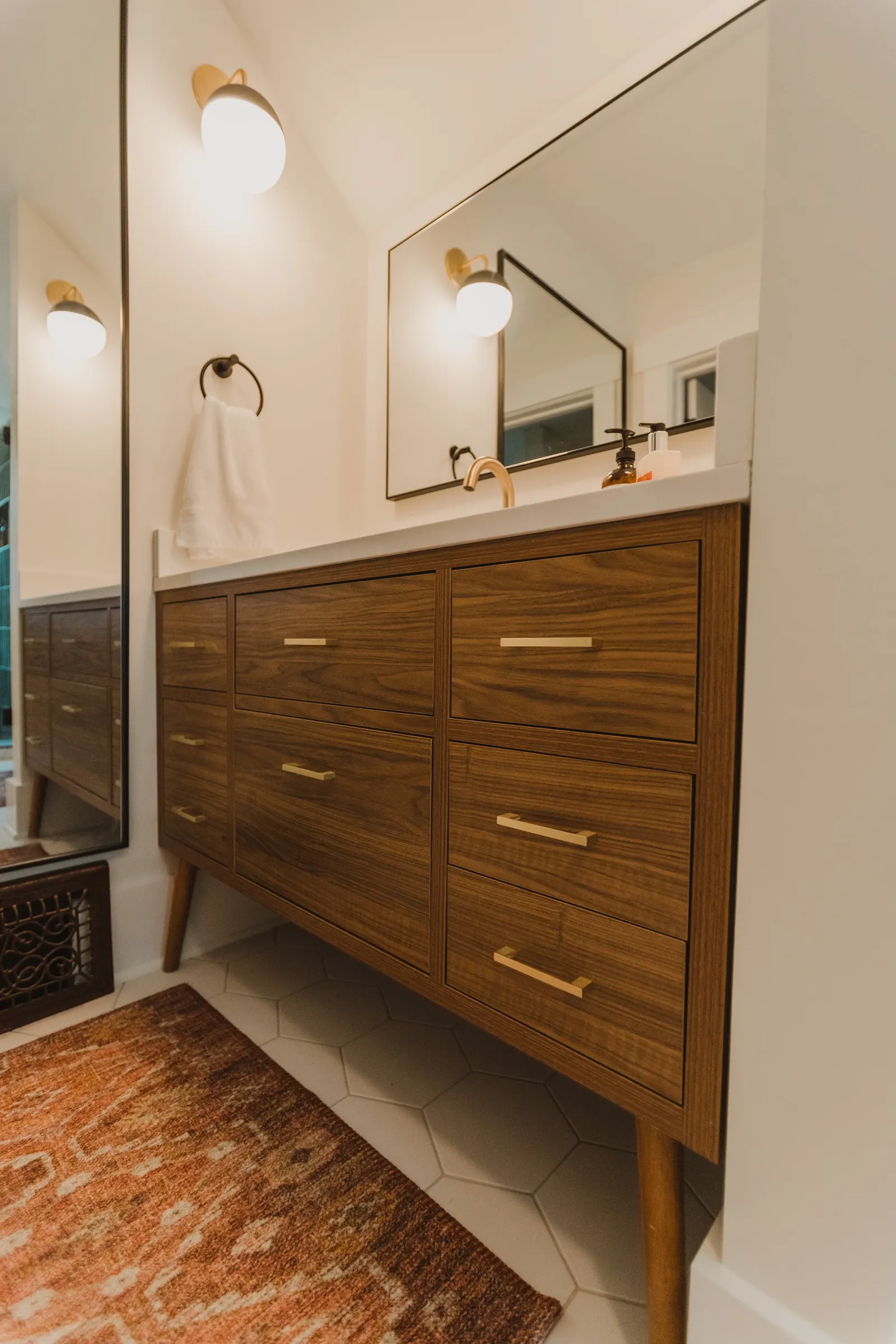 1920 Bathroom Remodel, custom wood vanity, brushed gold hardware, brushed gold sconces, modern design, mixed metal finishes, green subway tile, white hexagon floor tile, Lincoln Nebraska, professional contractors, remodeling and renovations.