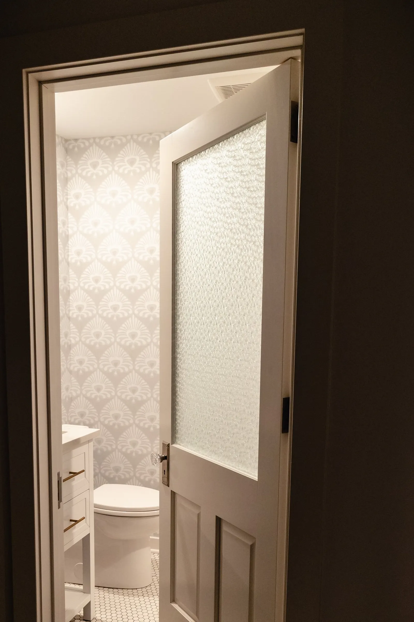 1922 Bathroom Remodel, whole home remodel, vintage door, vintage hardware, wallpaper, brushed gold finishes, open shelving, floating shelves, Lincoln Nebraska, professional contractors, remodeling and renovations.