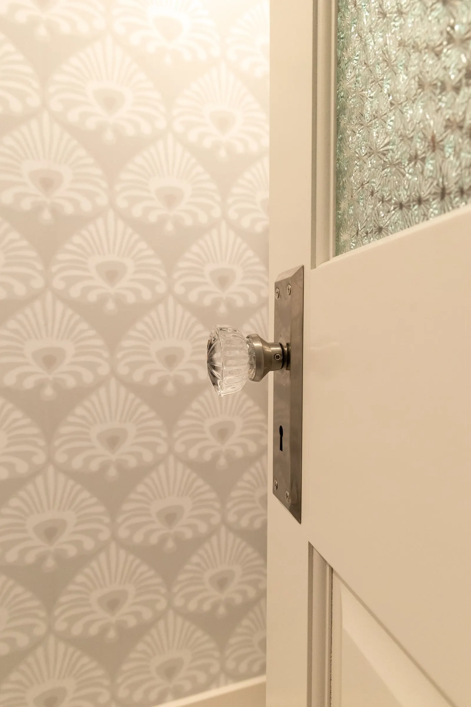 1922 Bathroom Remodel, whole home remodel, vintage door, vintage hardware, wallpaper, brushed gold finishes, open shelving, floating shelves, Lincoln Nebraska, professional contractors, remodeling and renovations.
