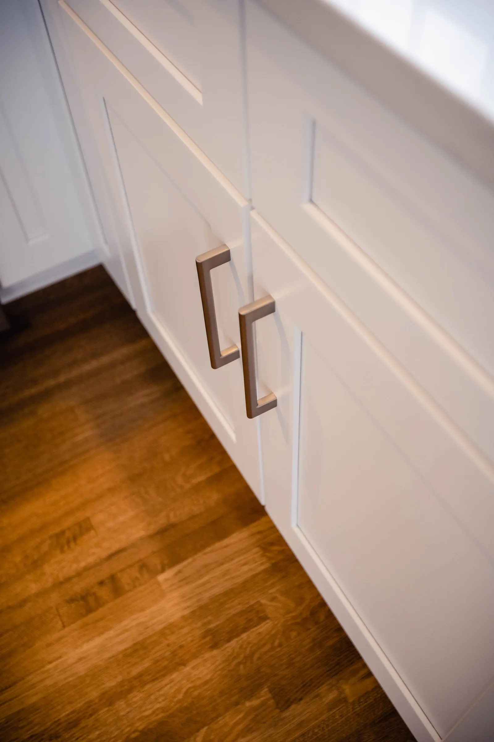 1922 Kitchen Remodel, Whole Home Remodel, brushed nickel hardware, white herringbone backsplash, custom white cabinets, wood floors, stainless steel appliances, white quartz countertops, open shelving, Lincoln Nebraska, professional contractors.