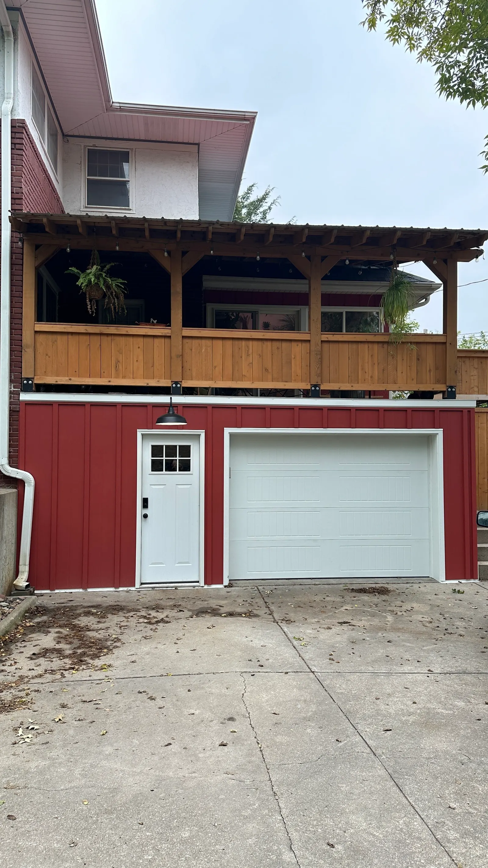 1923 Garage Remodel, Lincoln Nebraska, professional contractors, craftsmanship, red wood siding, matte black light fixture.