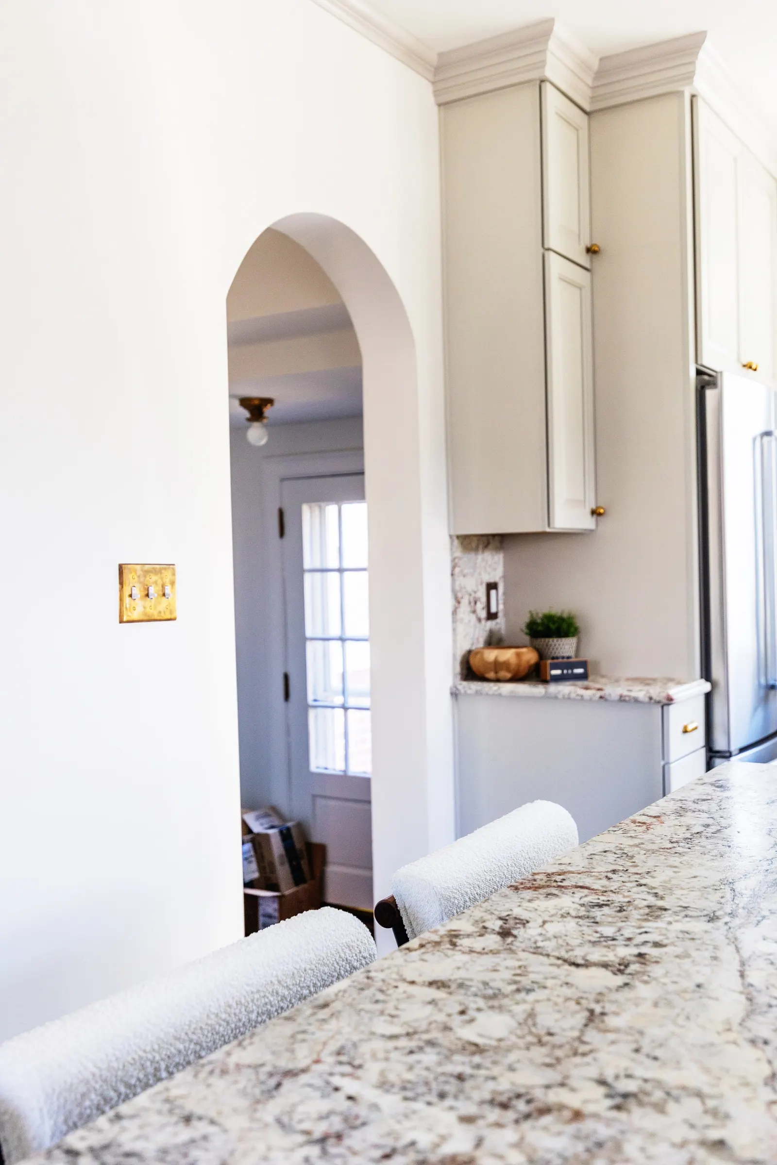 Close-up of a granite kitchen countertop with a kitchen cabinet in the background.