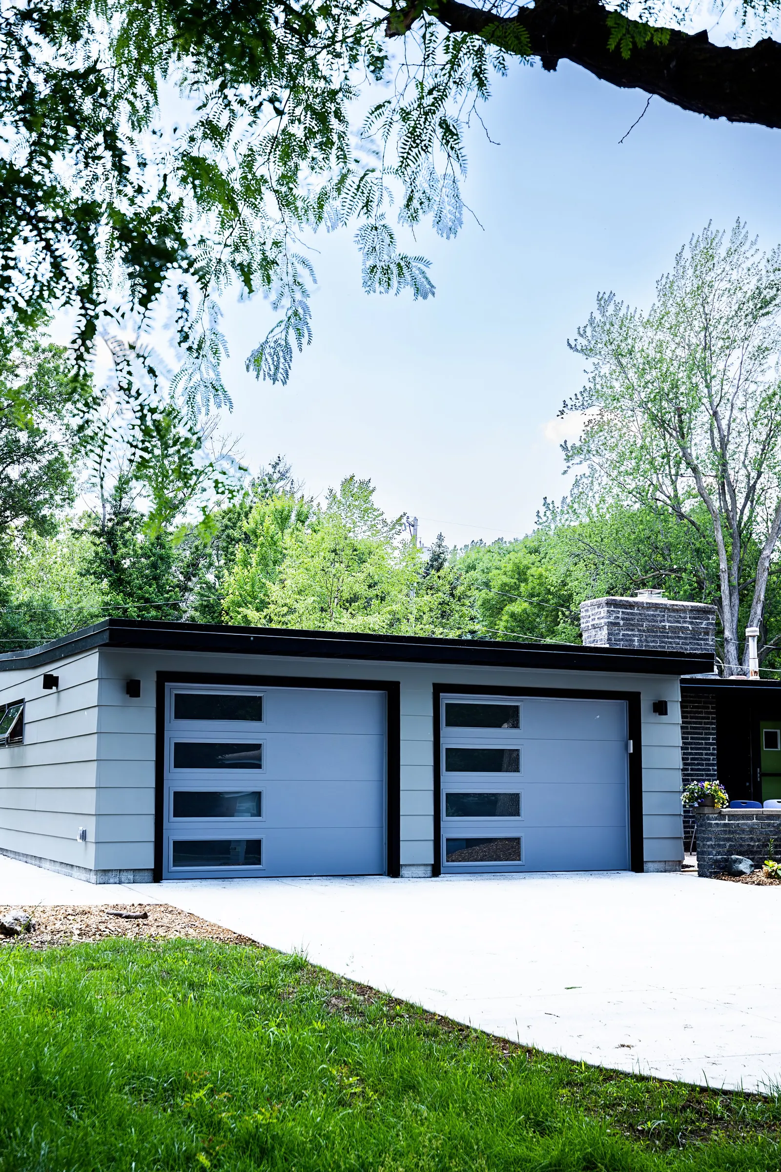 1956 Carport to Garage Transformation, Lincoln Nebraska, professional contractors, craftsmanship, matte black sconces, mid century modern design, gray garage door