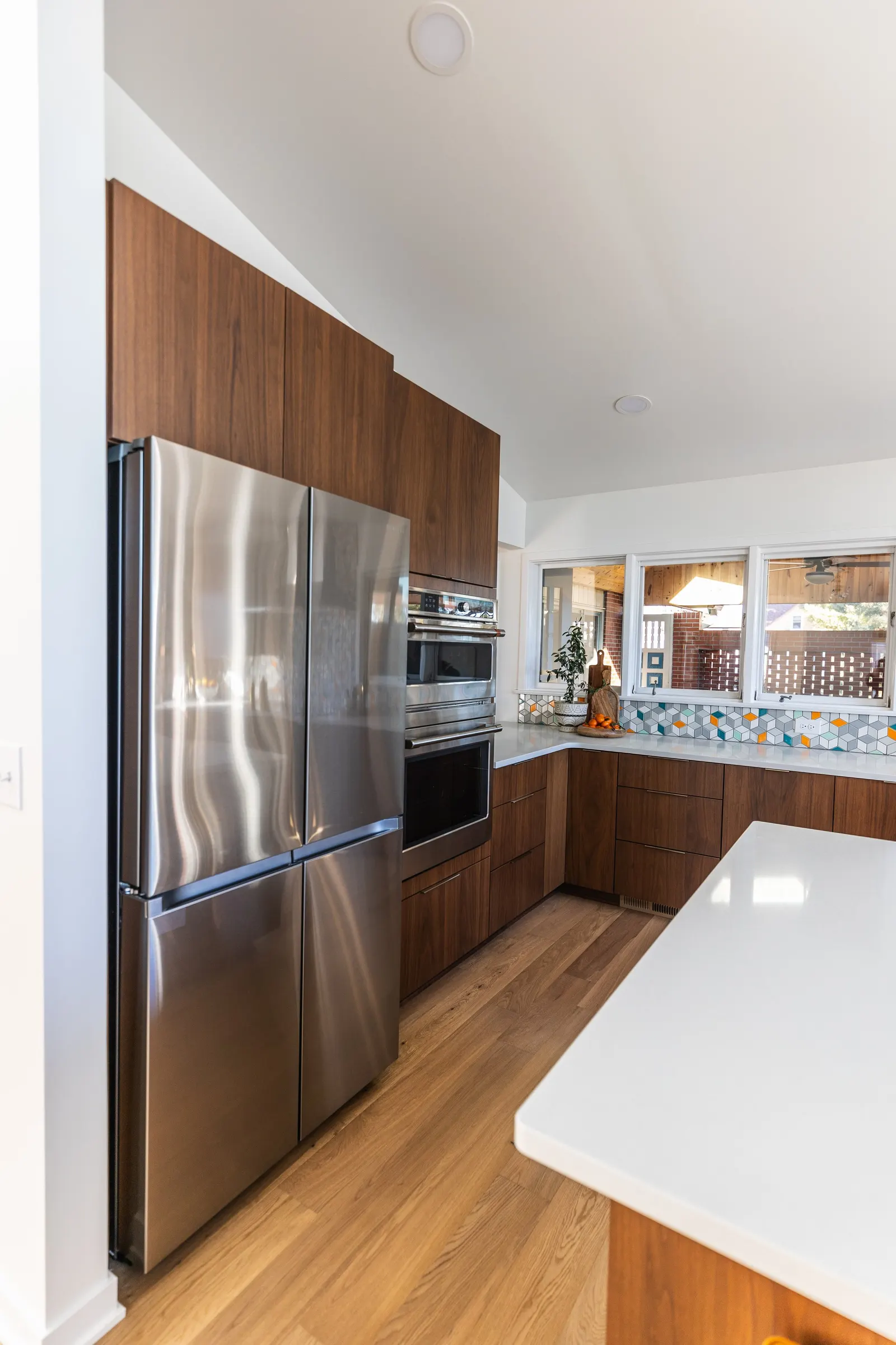1956 Kitchen Remodel, mid century modern design, mixed metals, wood cabinets, colorful tile backsplash, white quartz countertops, large windows, wood floors, vaulted ceilings, craftsmanship, custom cabinets, large island.