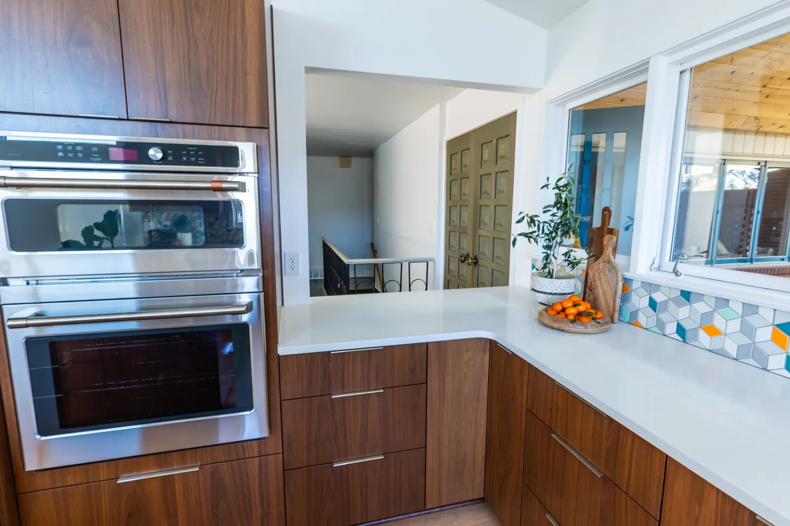 1956 Kitchen Remodel, mid century modern design, mixed metals, wood cabinets, colorful tile backsplash, white quartz countertops, large windows, wood floors, vaulted ceilings, craftsmanship, custom cabinets, large island.