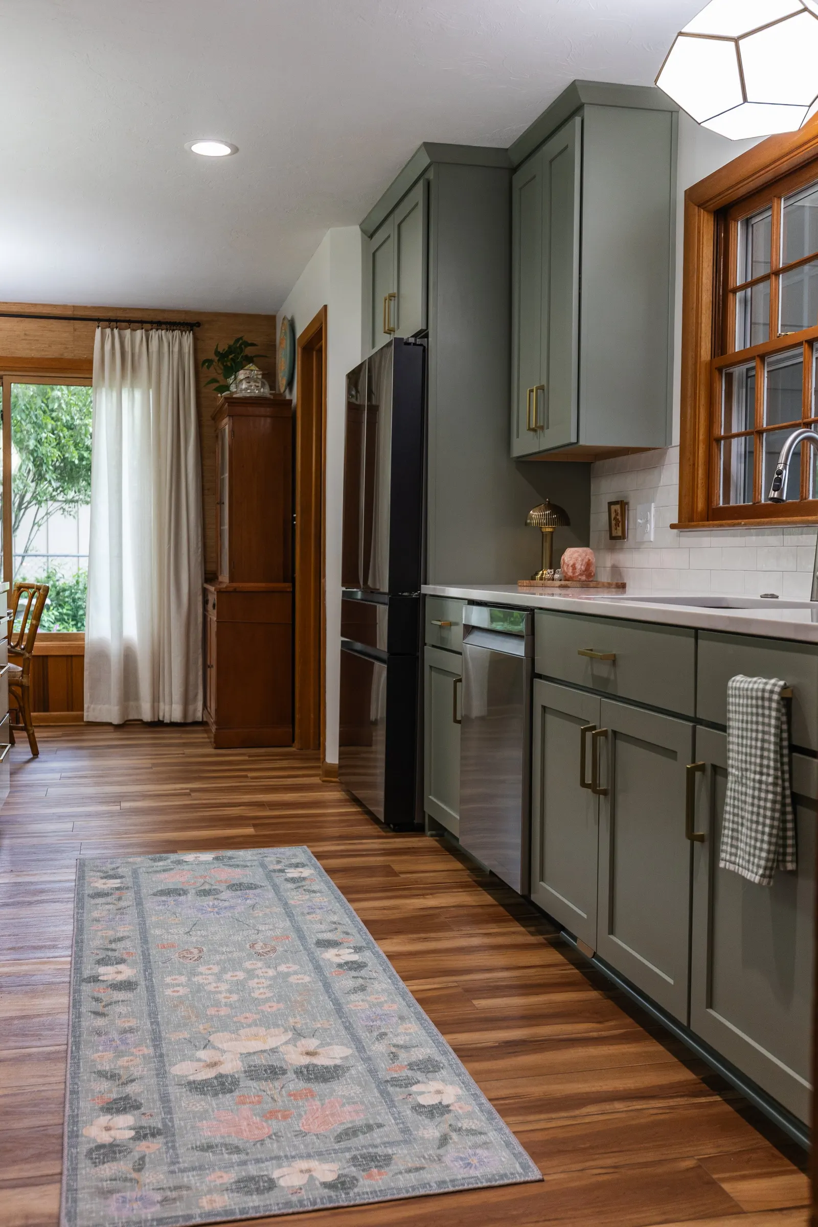 1958 Kitchen Remodel, mid century design, wood floors, stainless steel appliances, sage green cabinets, brushed gold hardware, white quartz countertop, modern light fixtures, Lincoln Nebraska, professional contractors, remodeling and renovations.
