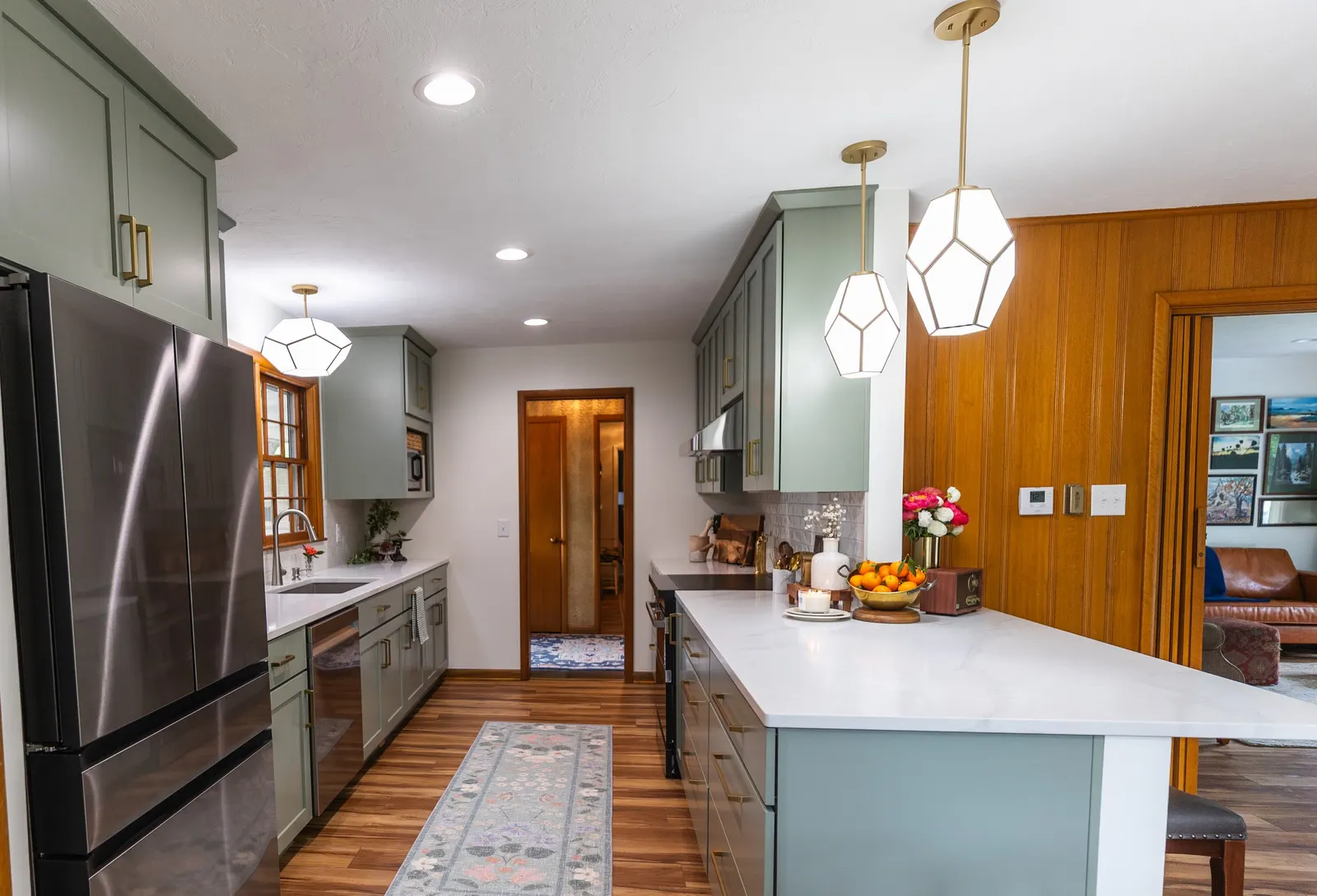 1958 Kitchen Remodel, mid century design, wood floors, stainless steel appliances, sage green cabinets, brushed gold hardware, white quartz countertop, modern light fixtures, Lincoln Nebraska, professional contractors, remodeling and renovations.