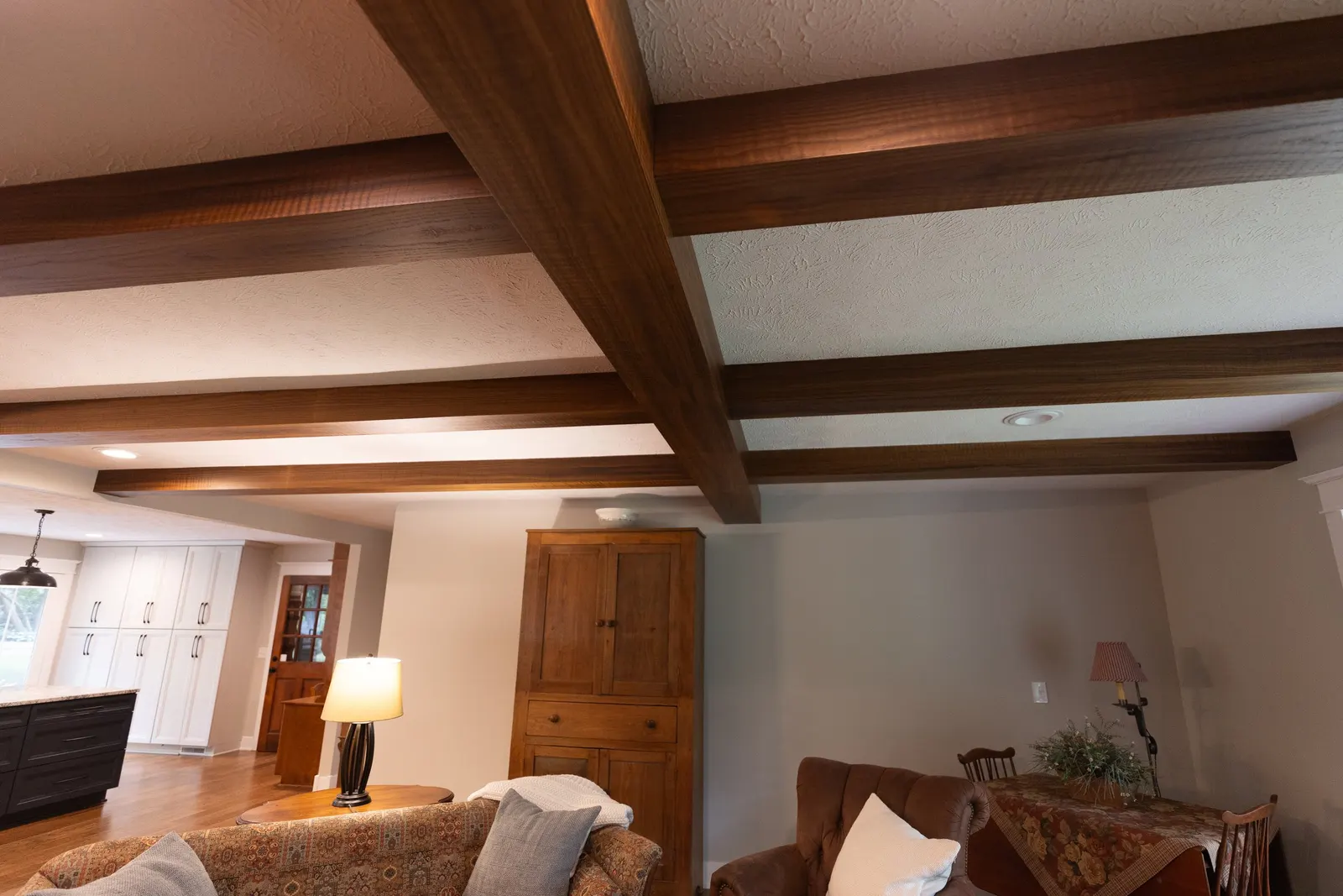 1974 Living Room Remodel, whole home remodel, wood floors, craftsmanship, farmhouse style, large windows, custom wood beams, brick fireplace, wood built-ins, can lighting, dark wood, craftsmanship, wood mantel.