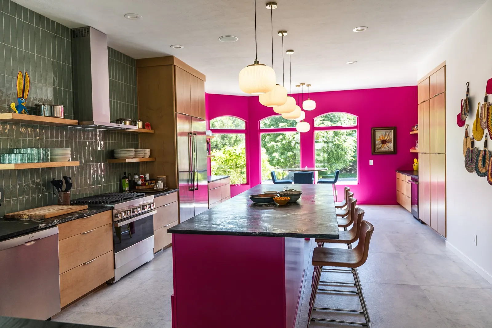2007 Kitchen Remodel, vibrant pink accents, green tile backsplash, wooden cabinets, brushed nickel hardware, quartz countertop, large island, pendant lights, open shelving, floating shelves, tile floor, coffee bar, wallpaper, eat in kitchen, addition
