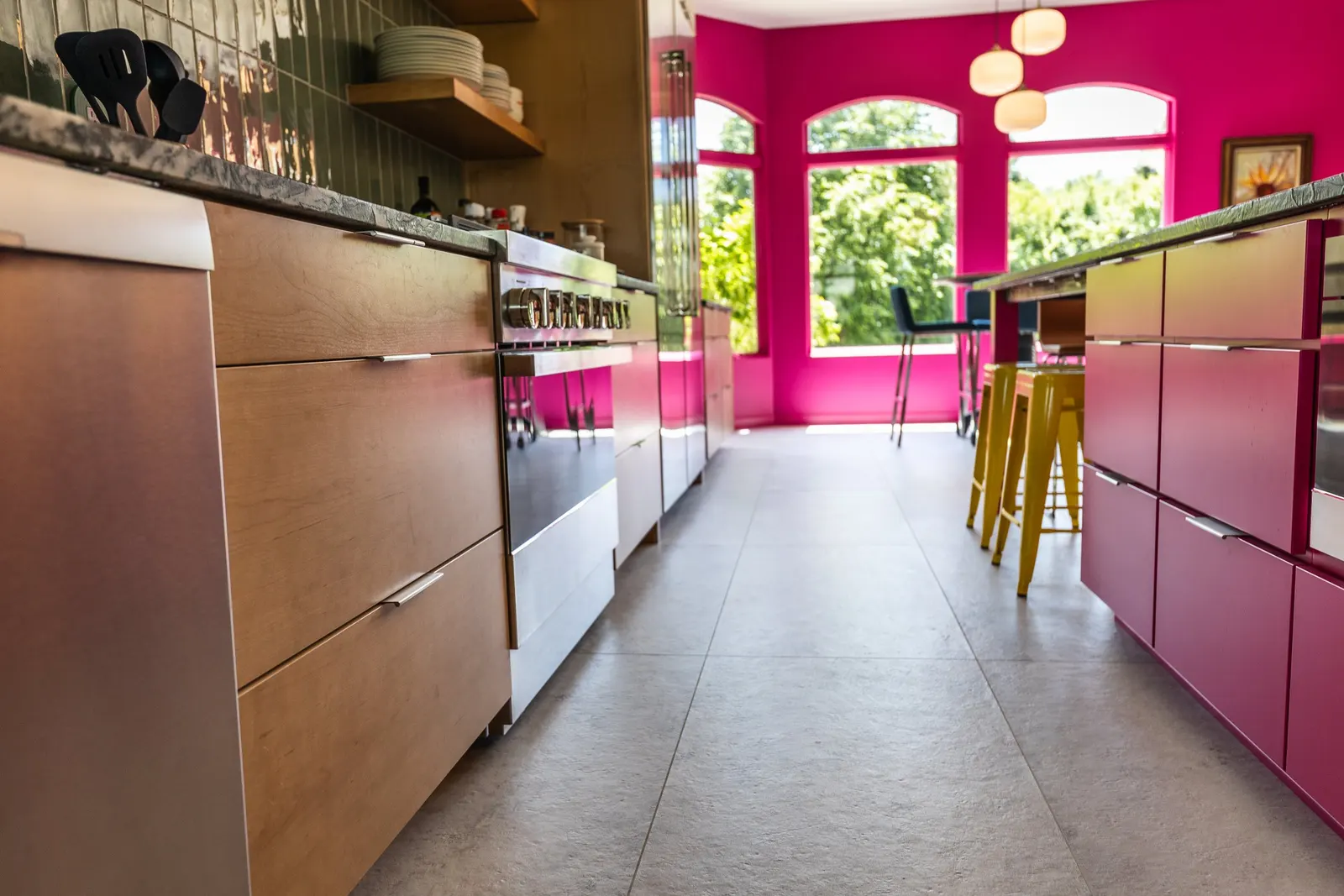 2007 Kitchen Remodel, vibrant pink accents, green tile backsplash, wooden cabinets, brushed nickel hardware, quartz countertop, large island, pendant lights, open shelving, floating shelves, tile floor, coffee bar, wallpaper, eat in kitchen, addition