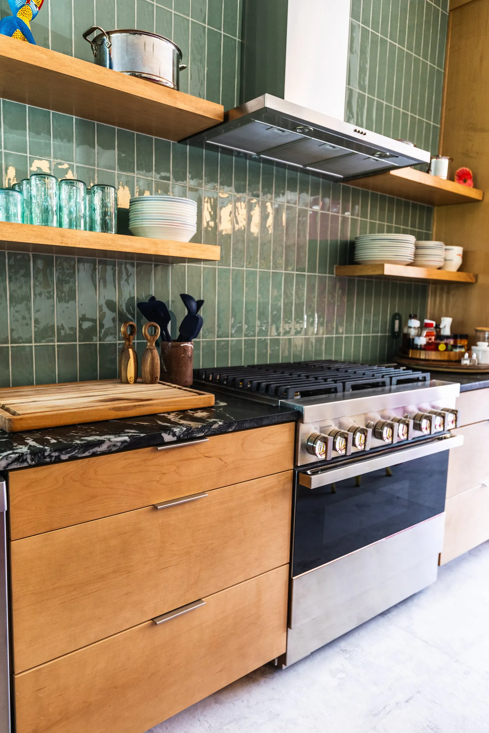 2007 Kitchen Remodel, vibrant pink accents, green tile backsplash, wooden cabinets, brushed nickel hardware, quartz countertop, large island, pendant lights, open shelving, floating shelves, tile floor, coffee bar, wallpaper, eat in kitchen, addition