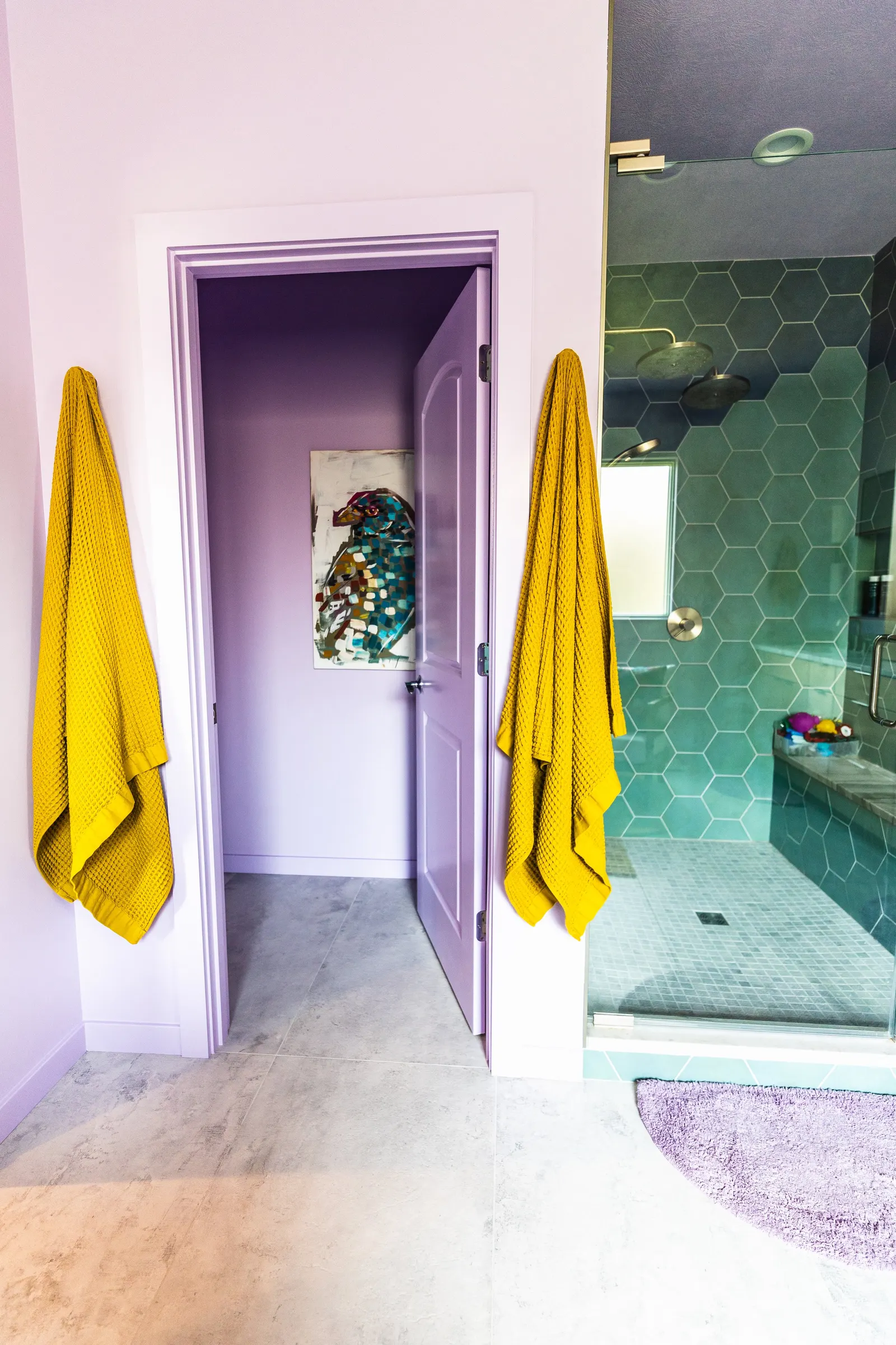 2007 Primary En-Suite Remodel, color drenching, violet, large windows, unique light fixtures, primary suite, tile floors, bathtub, hexagon tile, brushed nickel fixtures, brushed nickel hardware, bathroom suite, wood vanity, bathroom storage.