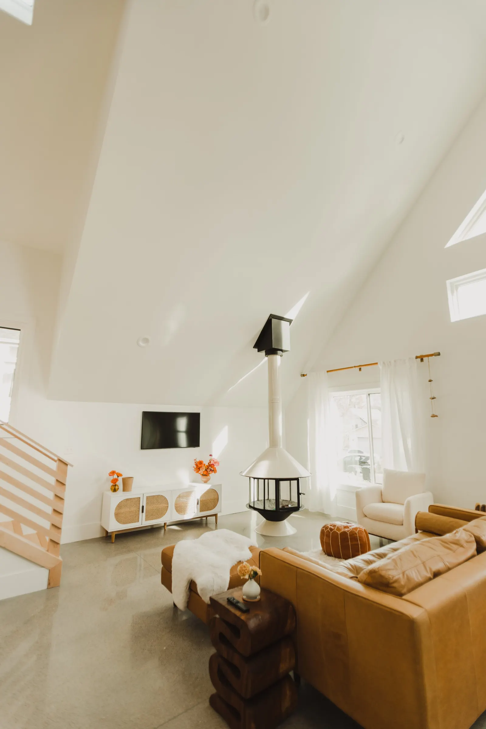 Living room with a high, sloped ceiling, white walls, open-plan living room, high vaulted ceiling, large windows, Dahlia House, new build, custom home, Air bnb, mid century design, modern,