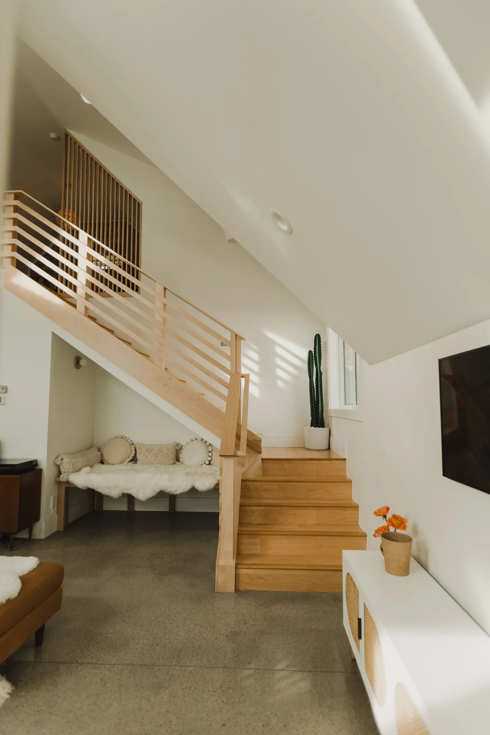 Living room with a staircase, high vaulted ceiling, large windows, Dahlia House, new build, custom home, Air bnb, mid century design, modern, boho chic, custom staircase, craftsmanship