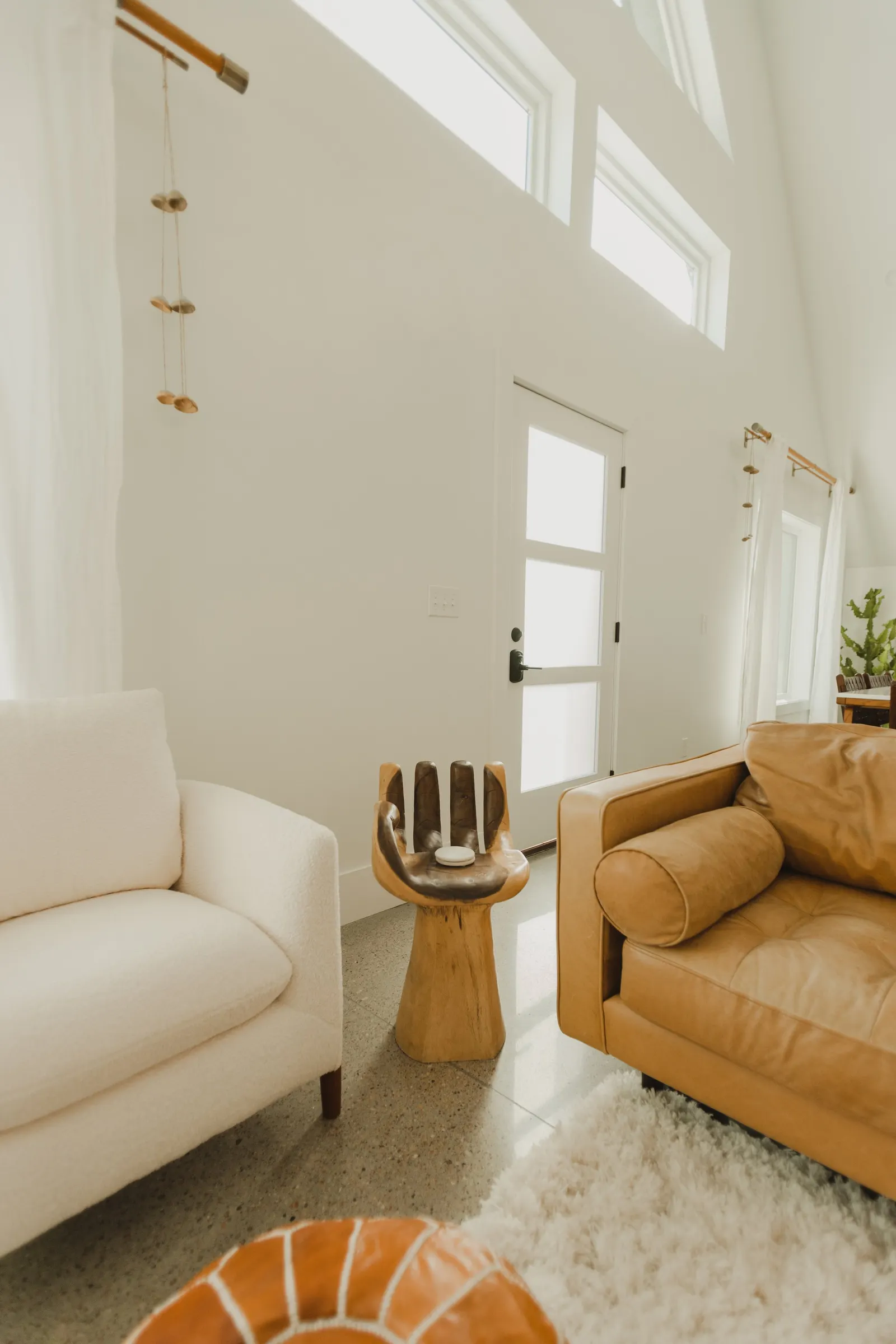 Modern living room, cement floors, open-plan living room, high vaulted ceiling, large windows, Dahlia House, new build, custom home, Air bnb, mid century design, modern, fireplace, modern design, fireplace, boho chic, craftsmanship