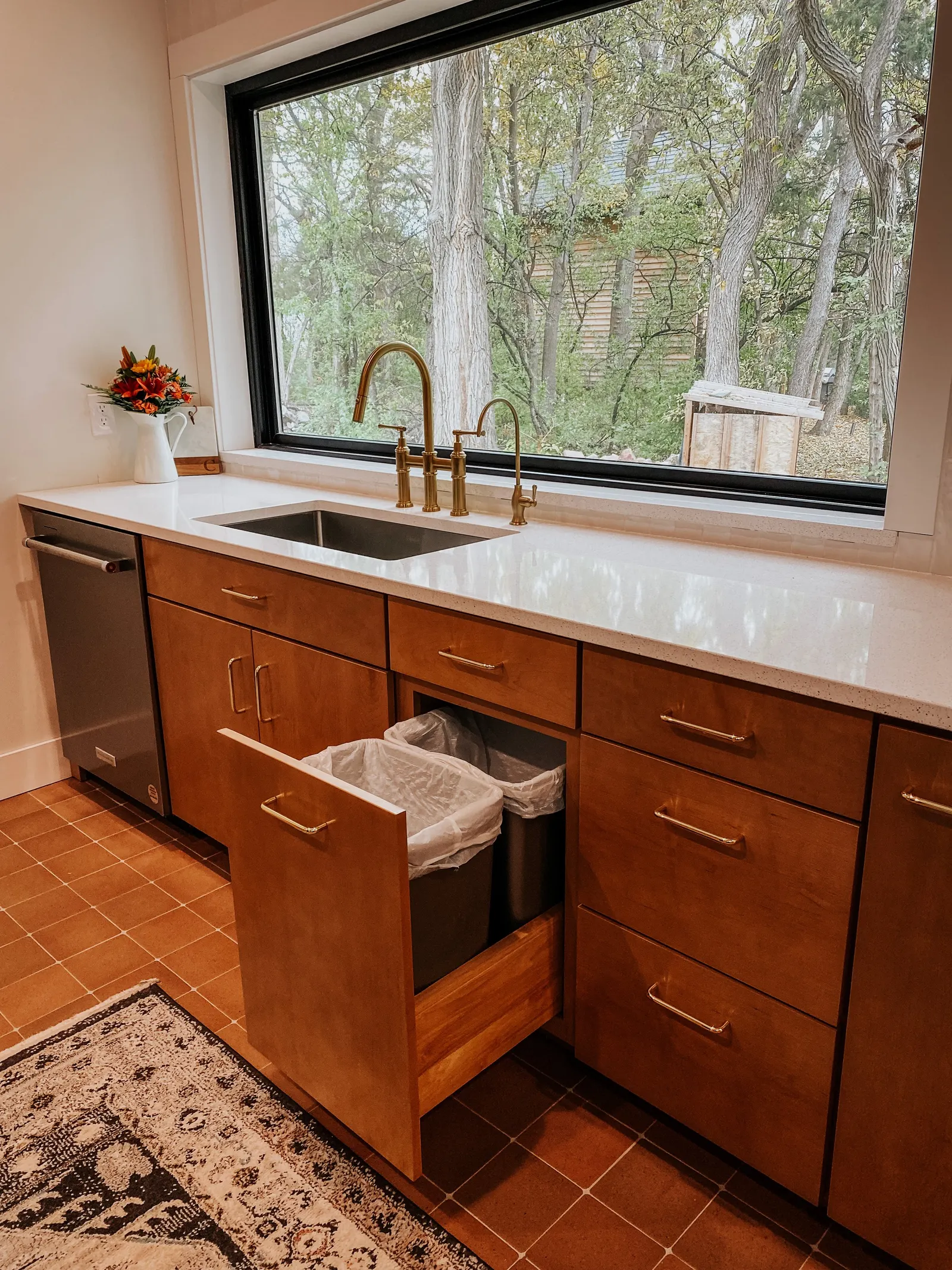 Forest House Kitchen Remodel, Whole Home Remodel, gold hardware, boho chic, farmhouse sink, custom hood, custom wood cabinets, tile floor, stainless steel appliances, white quartz countertops, large windows, wood beams, craftsmanship.