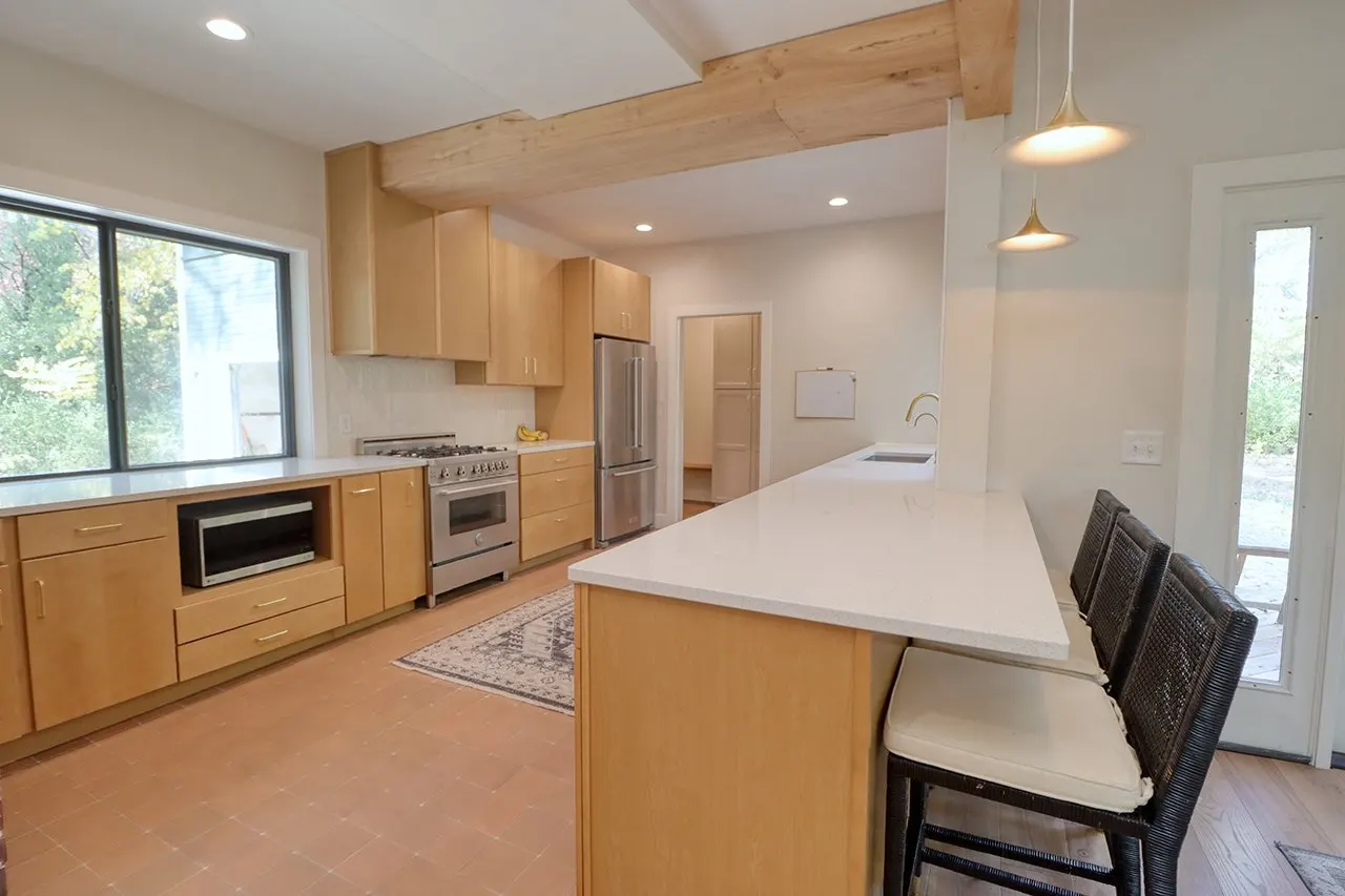 Forest House Kitchen Remodel, Whole Home Remodel, gold hardware, boho chic, farmhouse sink, custom hood, custom wood cabinets, tile floor, stainless steel appliances, white quartz countertops, large windows, wood beams, craftsmanship.