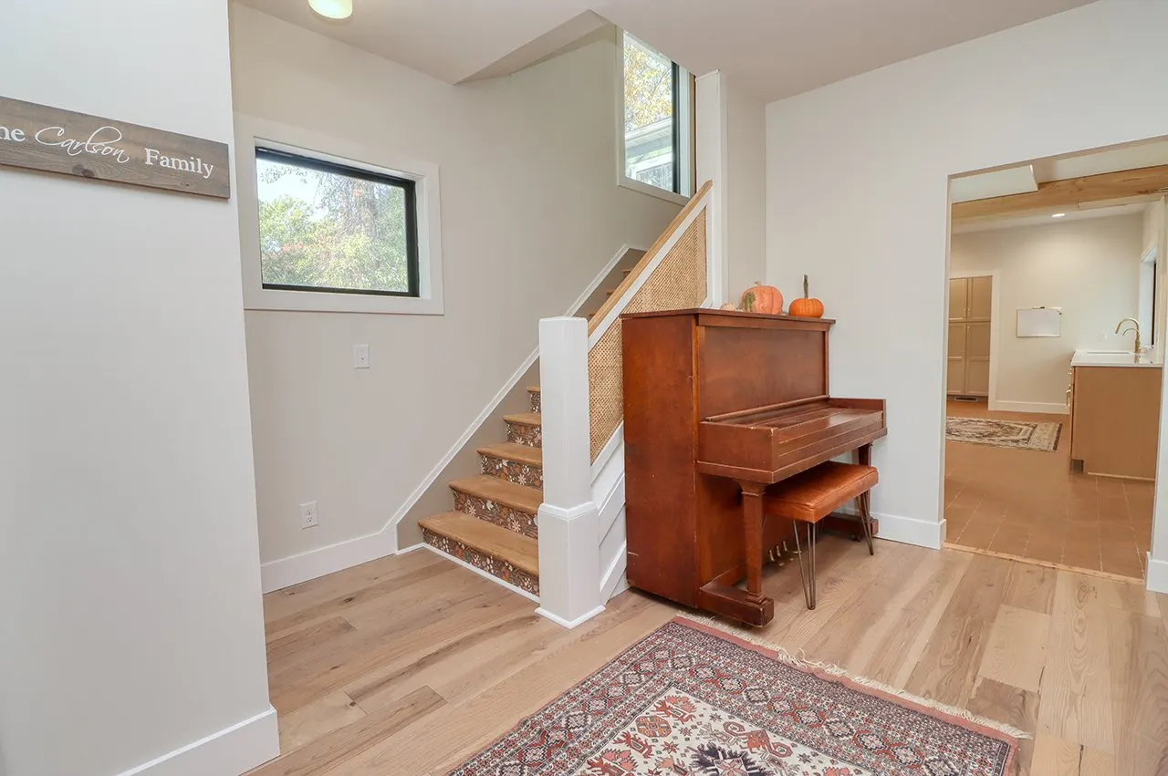 Forest House Remodel, whole home remodel, wallpaper stairs, wood floors, boho chic, mid century modern design, fireplace, open plan concept.