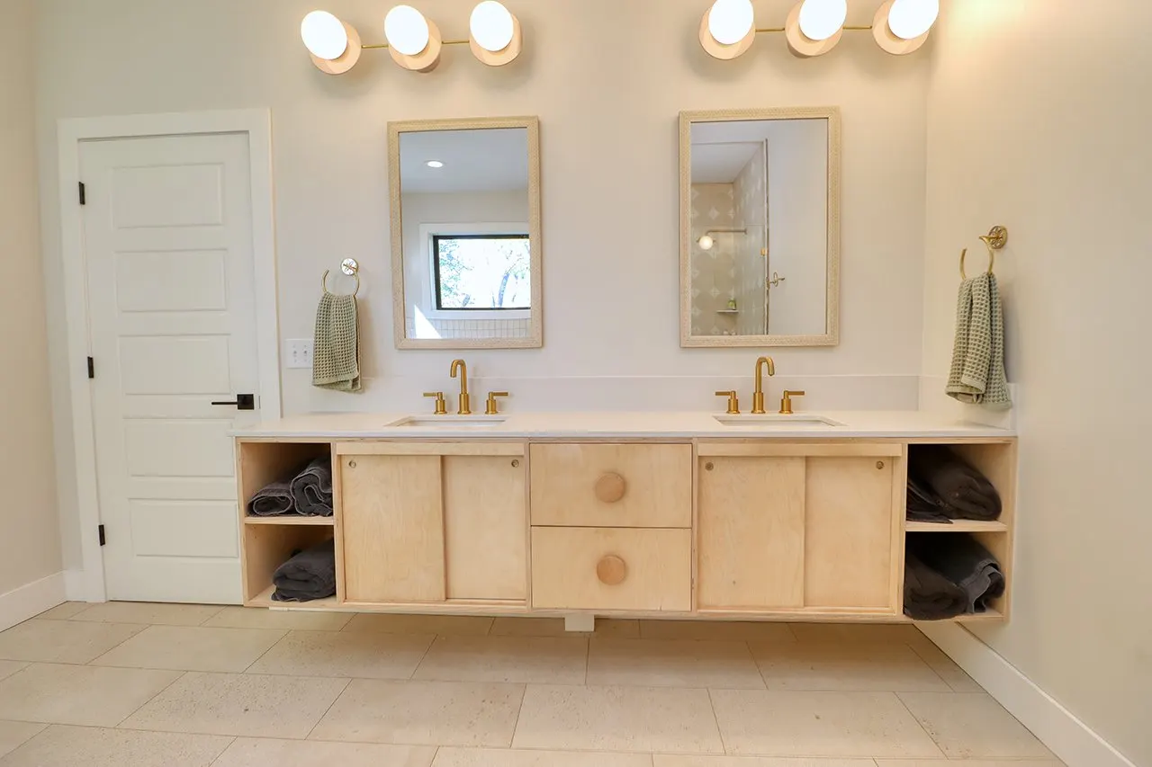 Forest House Remodel, whole home remodel, primary en-suite, free standing bathtub, walk-in shower, tile floor, large windows, mid century modern design, wood vanity, white quartz countertops, brass fixtures, custom vanity.